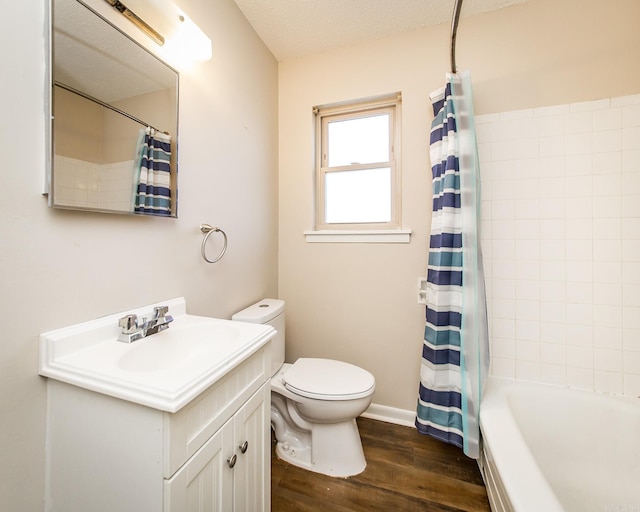 full bathroom featuring toilet, wood-type flooring, a textured ceiling, vanity, and shower / bath combo