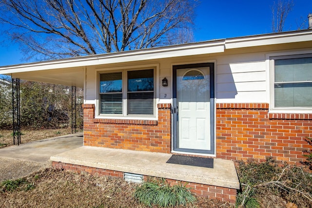 doorway to property featuring a carport