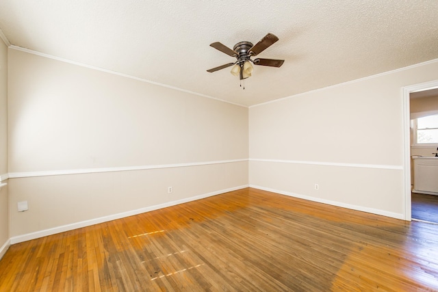 spare room featuring a textured ceiling, wood-type flooring, ornamental molding, and ceiling fan