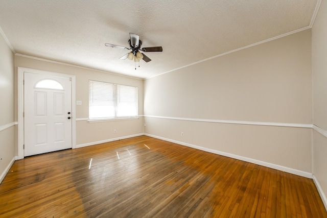 entryway featuring crown molding, dark wood-type flooring, a textured ceiling, and ceiling fan