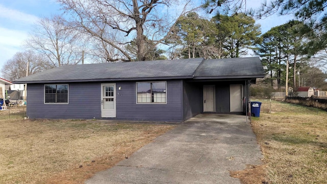 ranch-style home featuring a carport and a front lawn