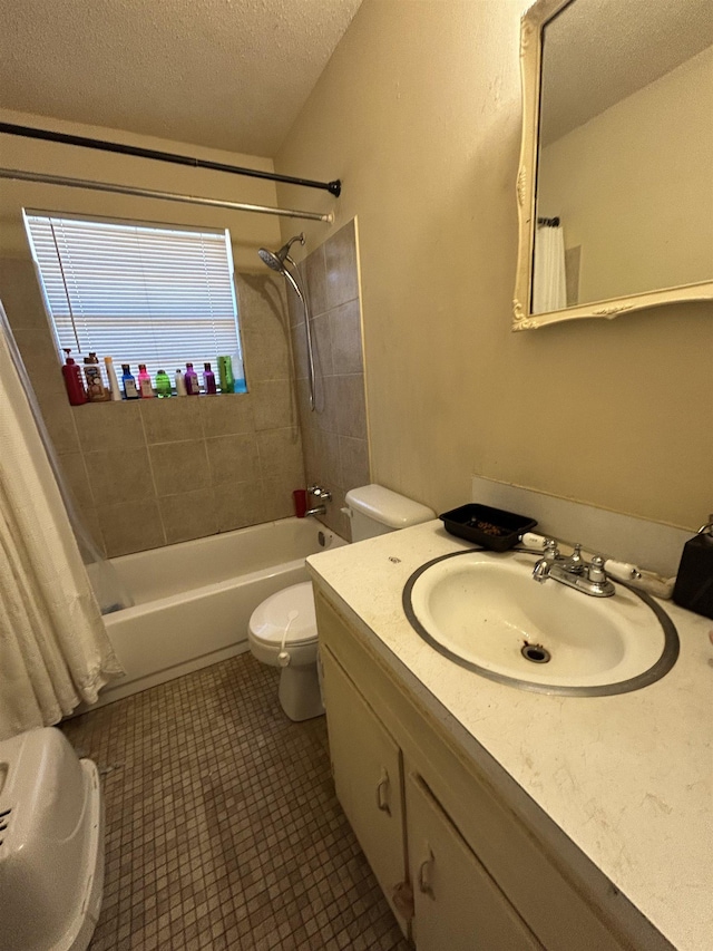 full bathroom with tile patterned flooring, vanity, a textured ceiling, toilet, and shower / bath combo with shower curtain