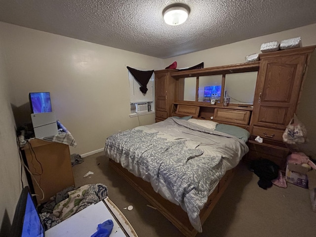 carpeted bedroom featuring cooling unit and a textured ceiling