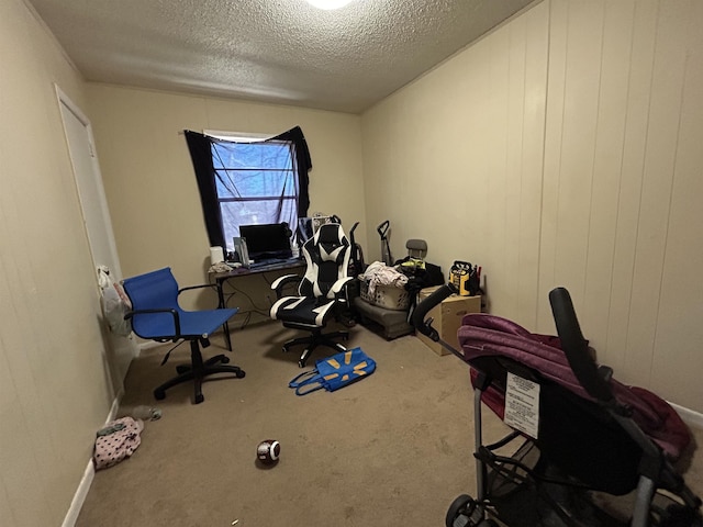 miscellaneous room with carpet and a textured ceiling