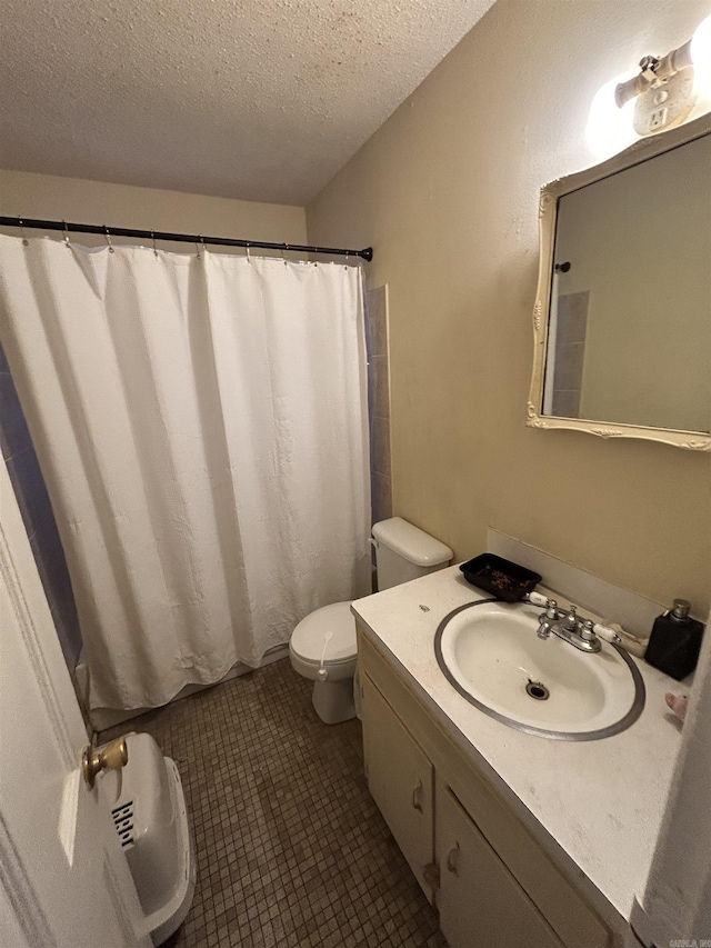 bathroom featuring vanity, a textured ceiling, curtained shower, tile patterned floors, and toilet