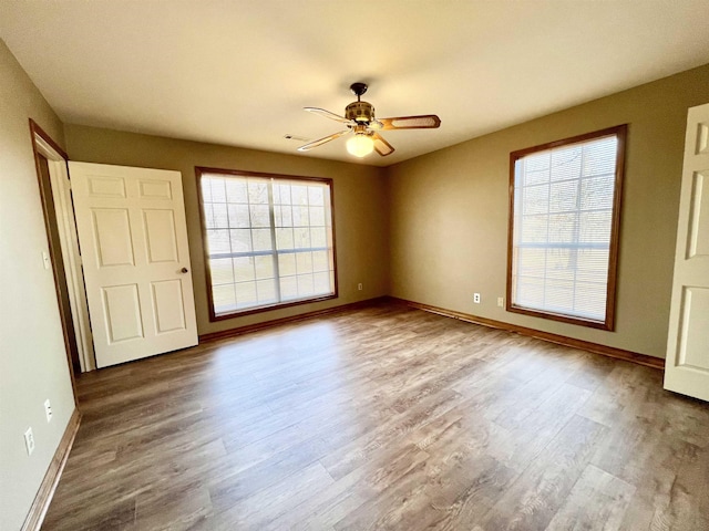 interior space with wood-type flooring and ceiling fan