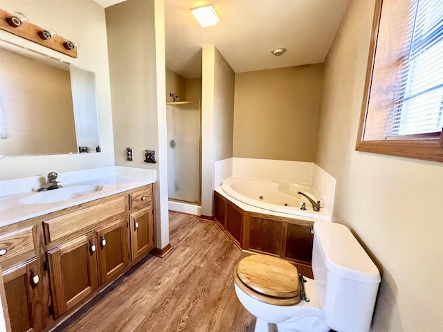 full bathroom with vanity, hardwood / wood-style flooring, plus walk in shower, and toilet