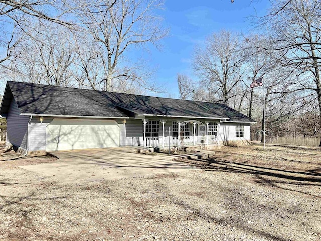 ranch-style home with a garage and covered porch