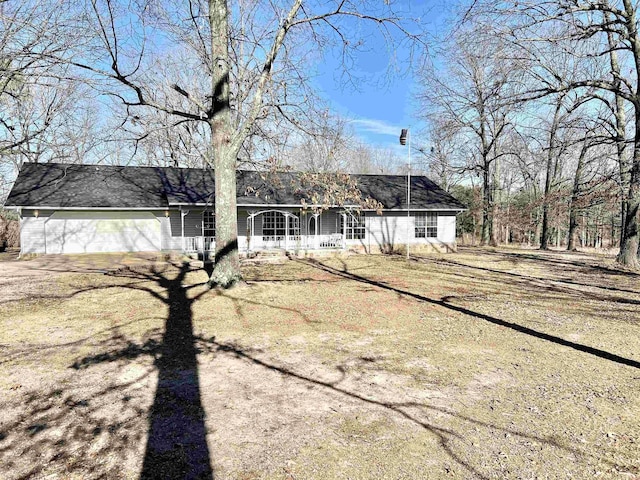 ranch-style home featuring a garage and a front yard