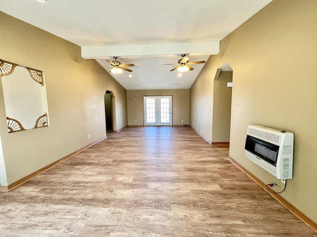 unfurnished living room with ceiling fan, light hardwood / wood-style flooring, heating unit, and vaulted ceiling with beams