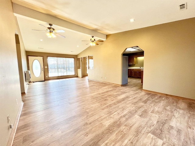 unfurnished living room with vaulted ceiling with beams, ceiling fan, and light wood-type flooring