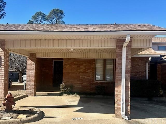 rear view of house featuring a carport