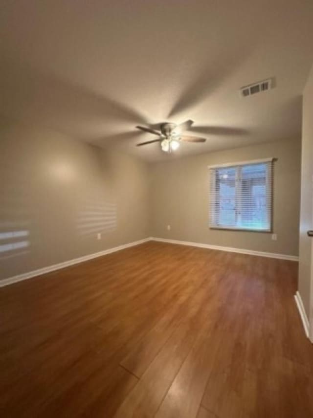 spare room with wood-type flooring and ceiling fan