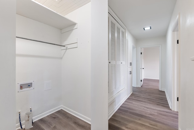 washroom featuring dark wood-type flooring and washer hookup