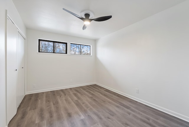 unfurnished bedroom with ceiling fan, wood-type flooring, and a closet