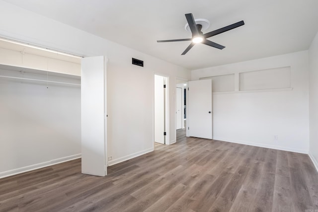 unfurnished bedroom featuring hardwood / wood-style flooring, a closet, and ceiling fan