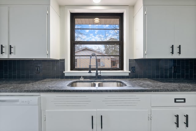 kitchen featuring sink, white cabinets, white dishwasher, and decorative backsplash