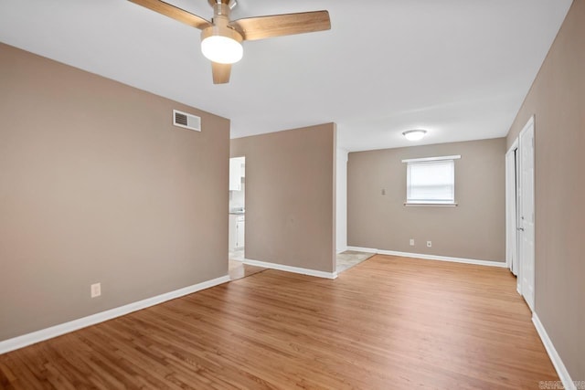 spare room featuring light hardwood / wood-style flooring and ceiling fan