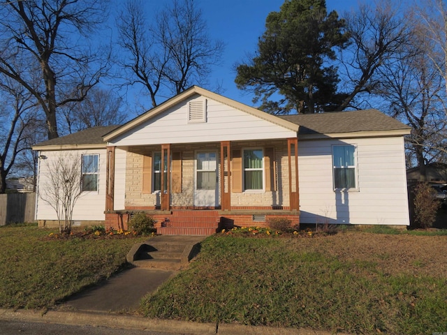 view of front facade with a porch and a front lawn