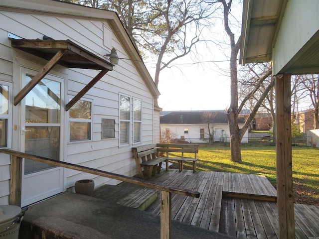 wooden terrace featuring a yard