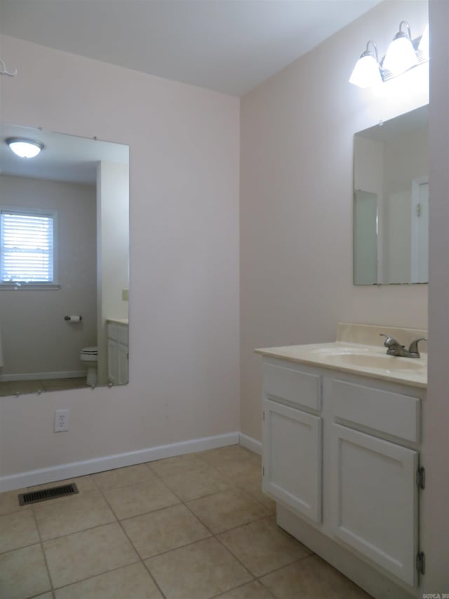 bathroom featuring vanity, toilet, and tile patterned flooring