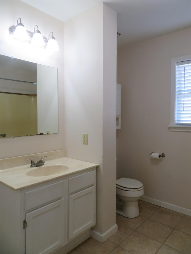 bathroom featuring vanity, a shower, tile patterned floors, and toilet