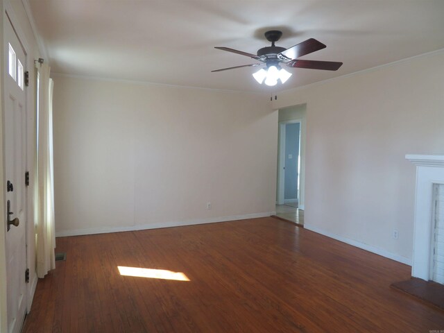 interior space featuring crown molding, ceiling fan, dark hardwood / wood-style floors, and a fireplace