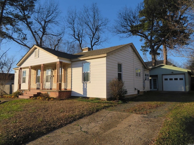 ranch-style house with a garage and covered porch