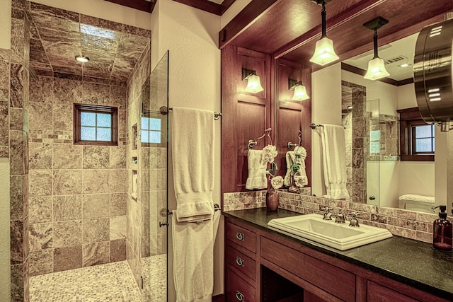 bathroom featuring vanity, an enclosed shower, and backsplash