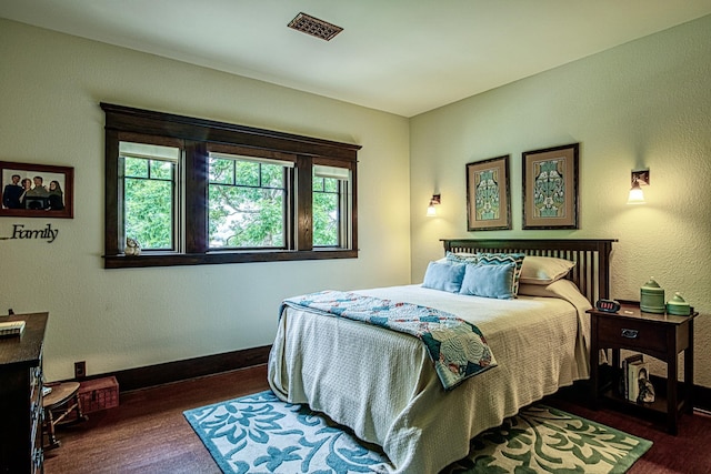 bedroom featuring dark hardwood / wood-style flooring