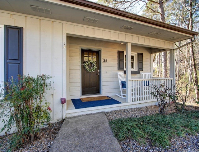 view of exterior entry with covered porch