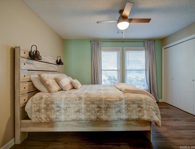 bedroom with a closet, ceiling fan, hardwood / wood-style floors, and a textured ceiling