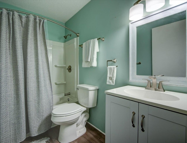 full bathroom featuring wood-type flooring, vanity, toilet, shower / bathtub combination with curtain, and a textured ceiling