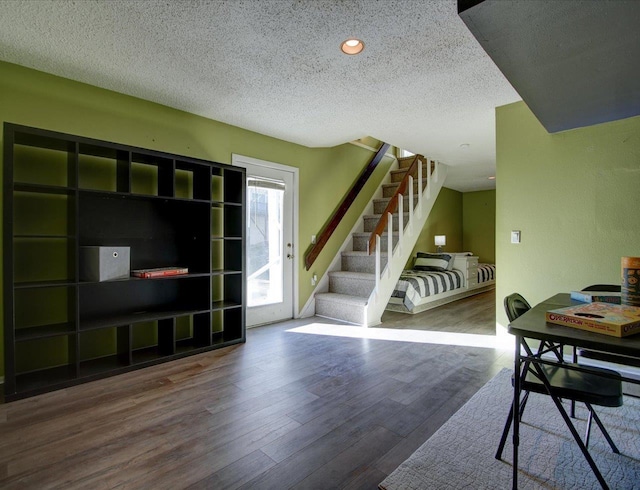 interior space featuring wood-type flooring and a textured ceiling