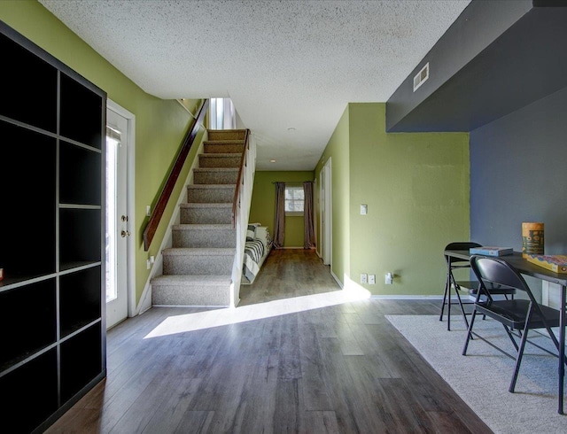 interior space with hardwood / wood-style floors and a textured ceiling