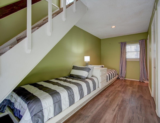 bedroom with hardwood / wood-style flooring and a textured ceiling