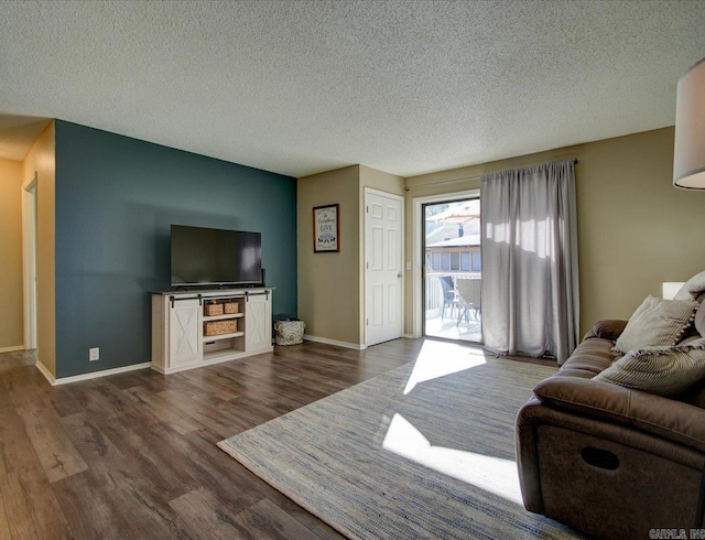 living room with dark hardwood / wood-style flooring and a textured ceiling