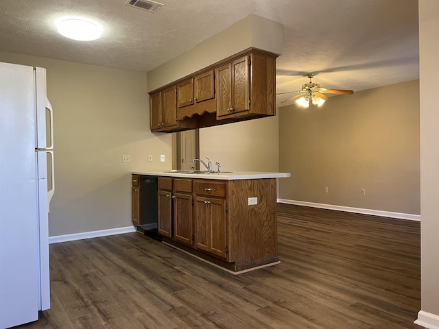 kitchen with dishwasher, sink, white refrigerator, ceiling fan, and dark wood-type flooring