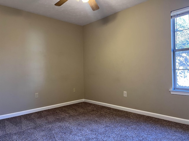 spare room with a textured ceiling, carpet floors, and ceiling fan