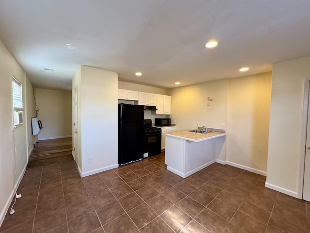 kitchen featuring white cabinetry, sink, black appliances, and kitchen peninsula