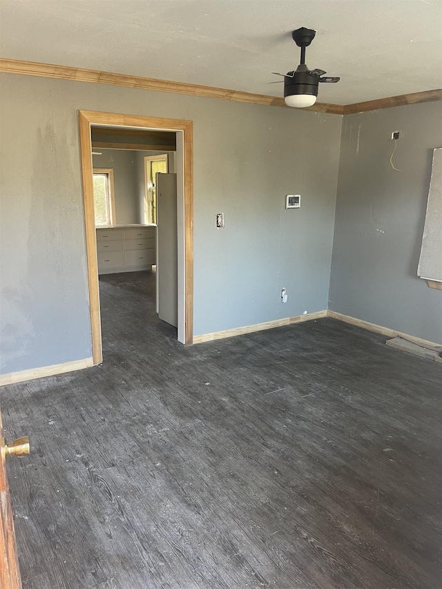 empty room with dark wood-type flooring and ceiling fan