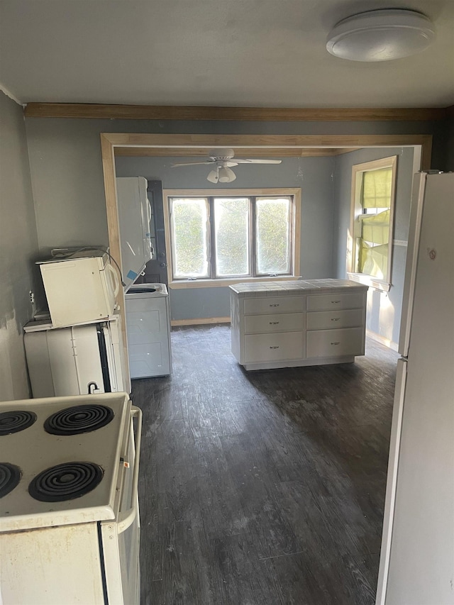 kitchen featuring washer / clothes dryer, white cabinets, ceiling fan, dark wood-type flooring, and white appliances