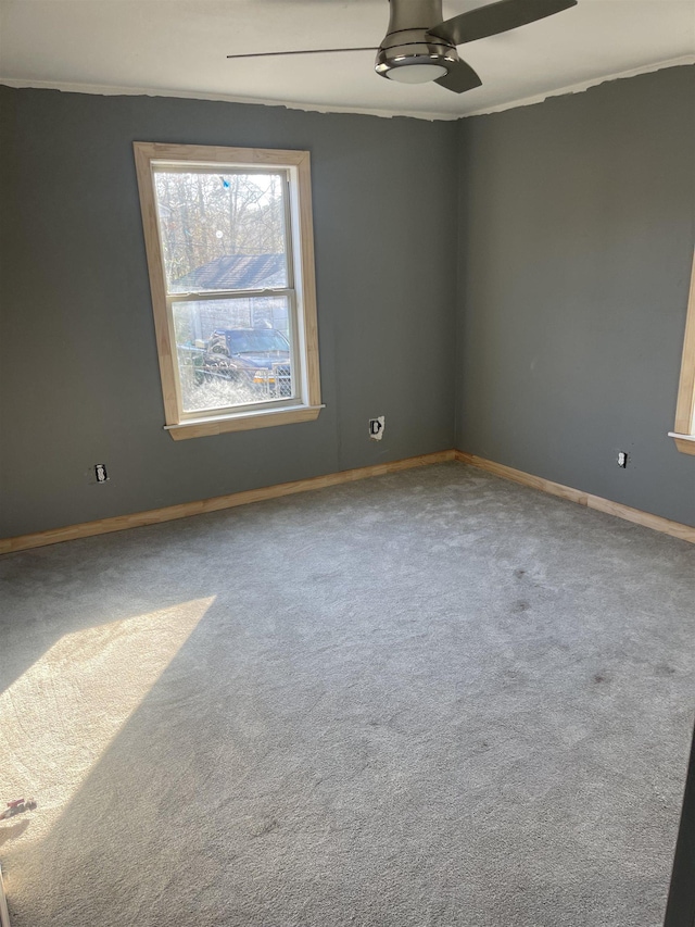 carpeted empty room featuring ceiling fan