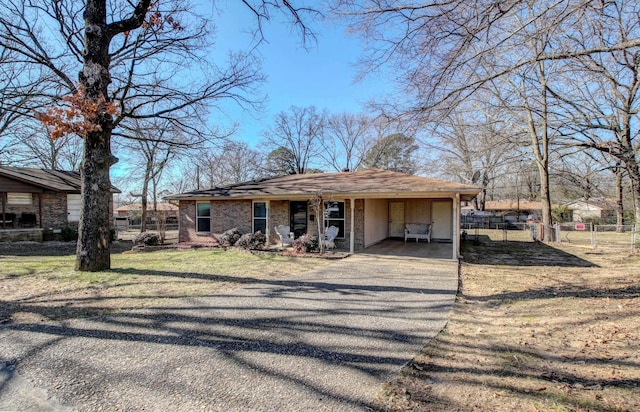 view of front of property featuring a carport and a front lawn