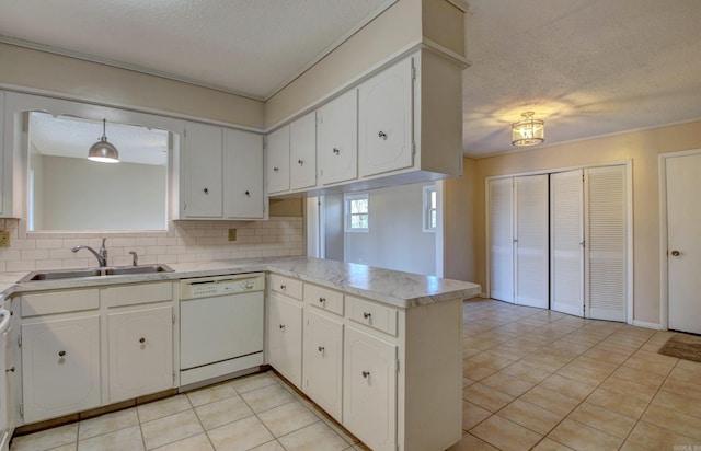 8 Woodmere Pl, Sherwood, AR 72120 - kitchen with white cabinetry, hanging light fixtures, dishwasher, kitchen peninsula, and backsplash