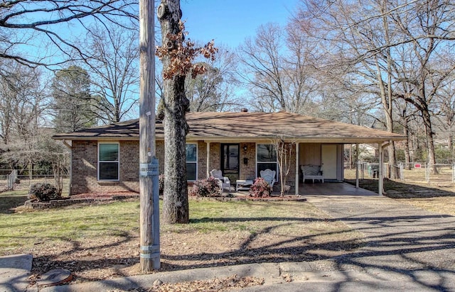 view of front of property with a carport, a porch, and a front lawn