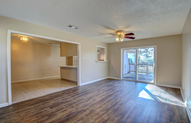 8 Woodmere Pl, Sherwood, AR 72120 - unfurnished living room featuring hardwood / wood-style floors, a textured ceiling, and ceiling fan