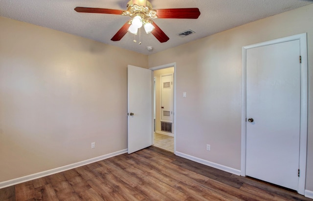 8 Woodmere Pl, Sherwood, AR 72120 - unfurnished bedroom with hardwood / wood-style flooring, a textured ceiling, and ceiling fan