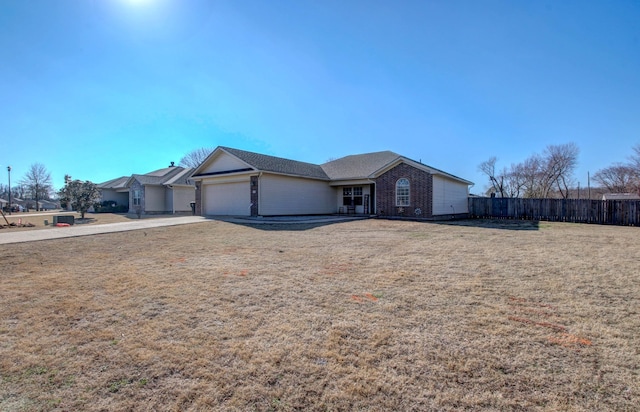 ranch-style house with a garage and a front yard