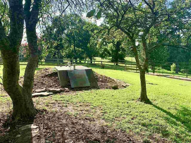 entry to storm shelter featuring a yard